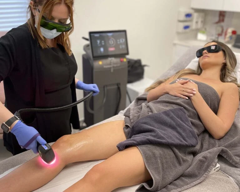 woman receiving laser hair removal on her calf